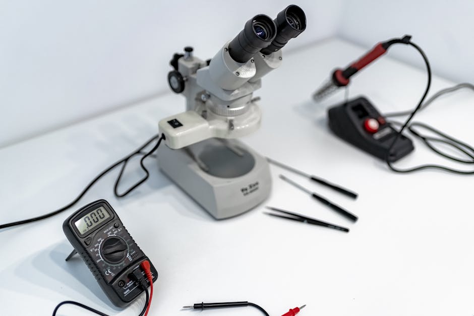 A laboratory workbench featuring a microscope, multimeter, and precision tools for scientific research.