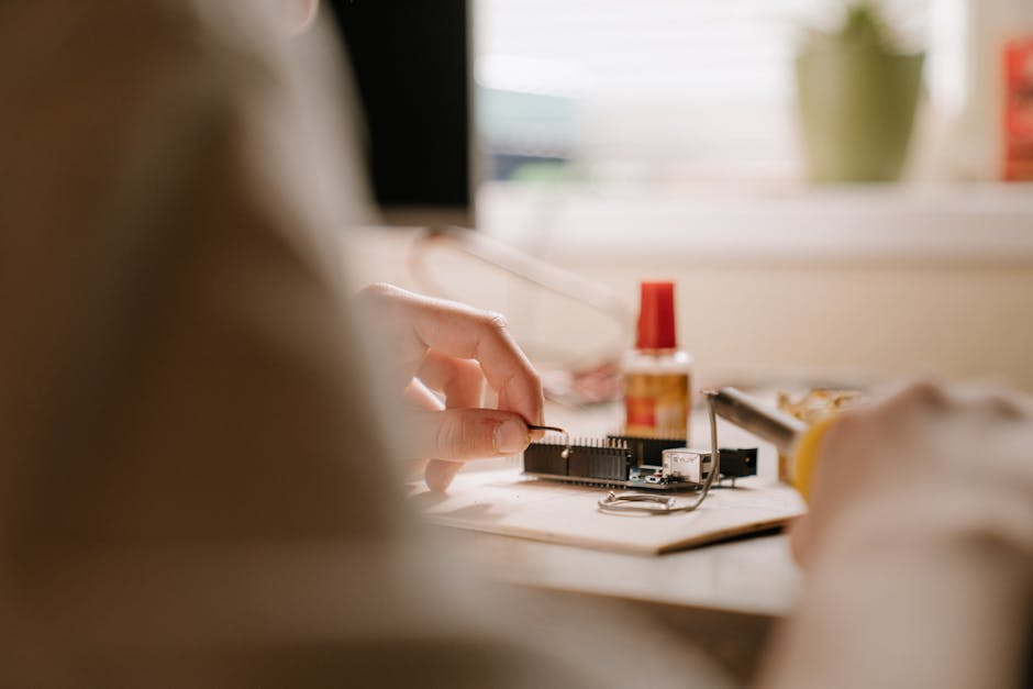 A detailed view of soldering a printed circuit board with tools indoors, ideal for technology enthusiasts.